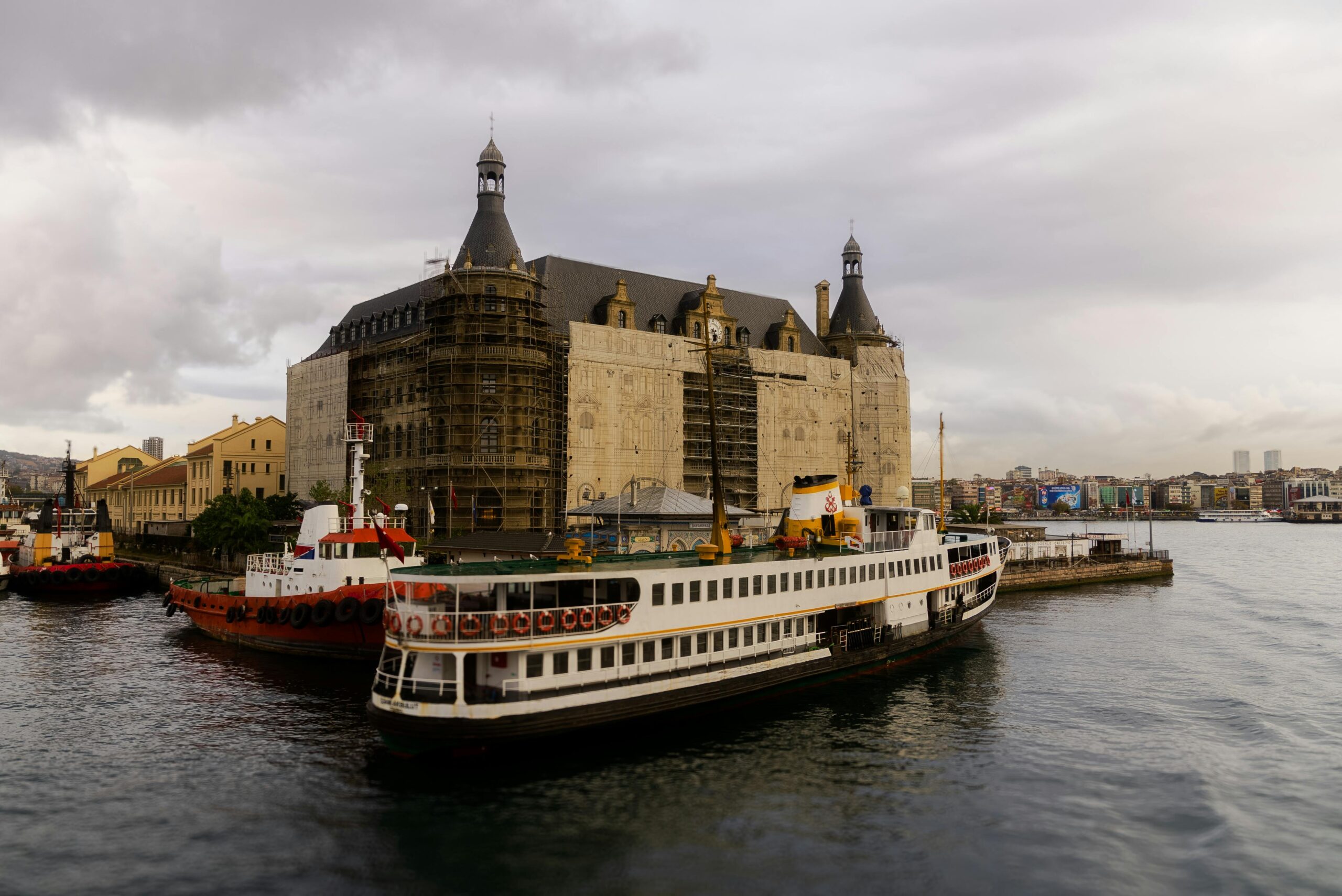 View of the iconic Haydarpaşa Terminal and ferry on Istanbul's Bosphorus waterfront.